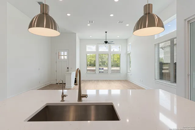 a kitchen with stainless steel appliances a refrigerator and a stove top oven