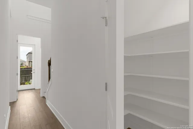 a kitchen with a refrigerator and a stove top oven
