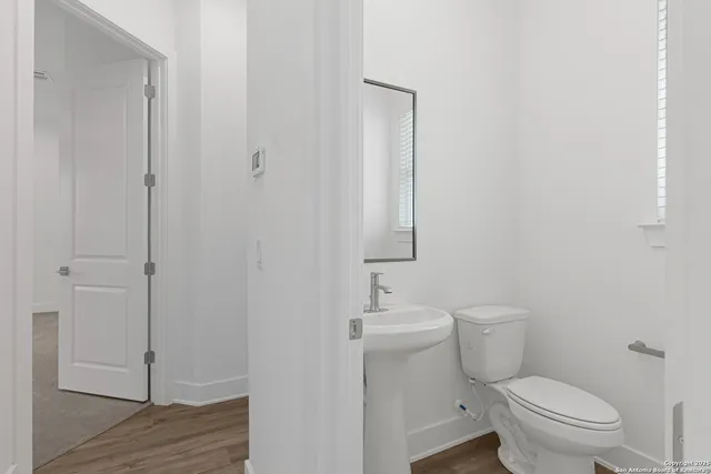 a bathroom with a sink a toilet and a mirror