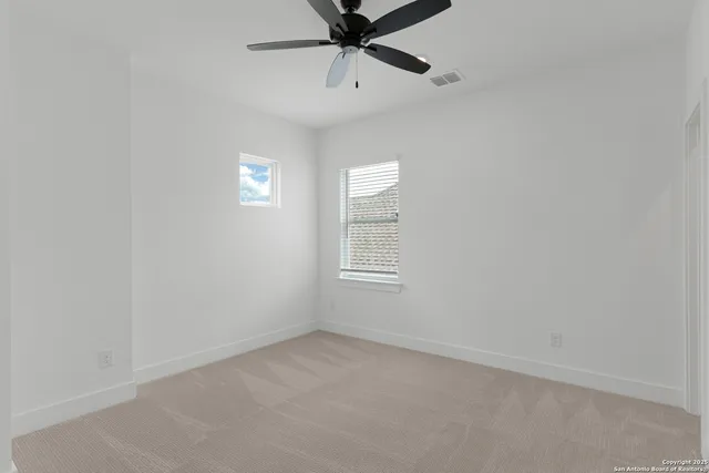 a view of a big room with a ceiling fan