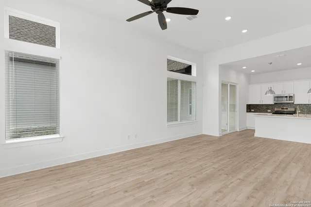 a view of kitchen with refrigerator and window