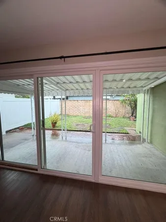 a view of a room with wooden floor and windows