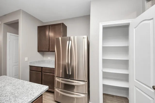 a kitchen with a refrigerator and cabinets