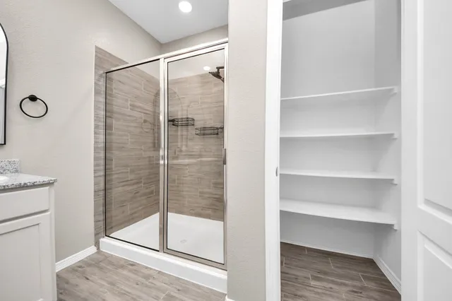 a bathroom with a glass shower door