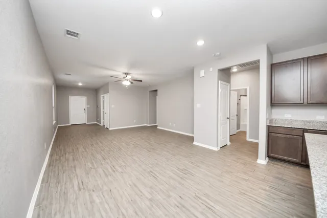a view of a kitchen with a sink and a refrigerator