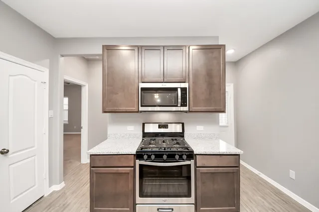 a kitchen with a stove and a microwave