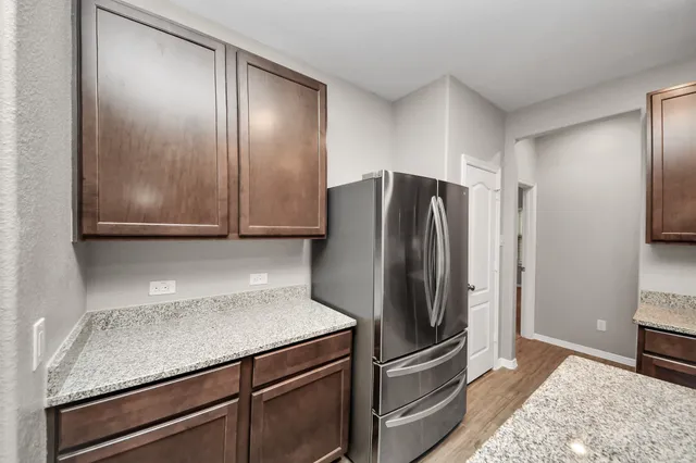a kitchen with metallic refrigerator freezer and a dishwasher