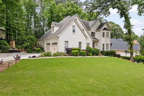 a front view of house with yard and green space