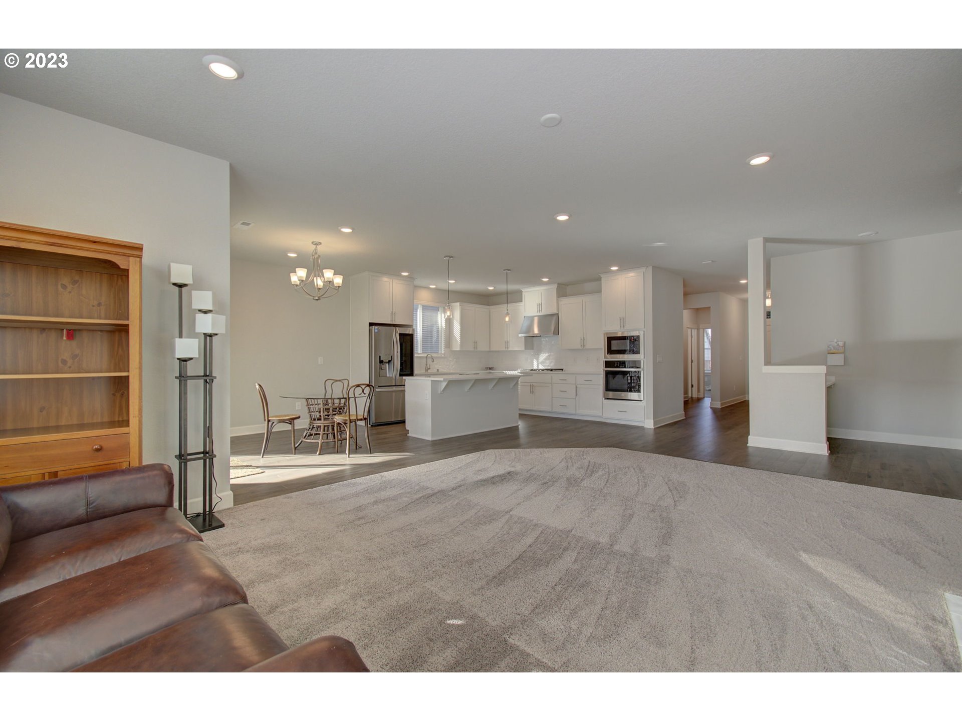 4823 South 16th Drive Ridgefield, WA 98642 - Photo 11 of 37 a view of a living room a refrigerator and a kitchen area