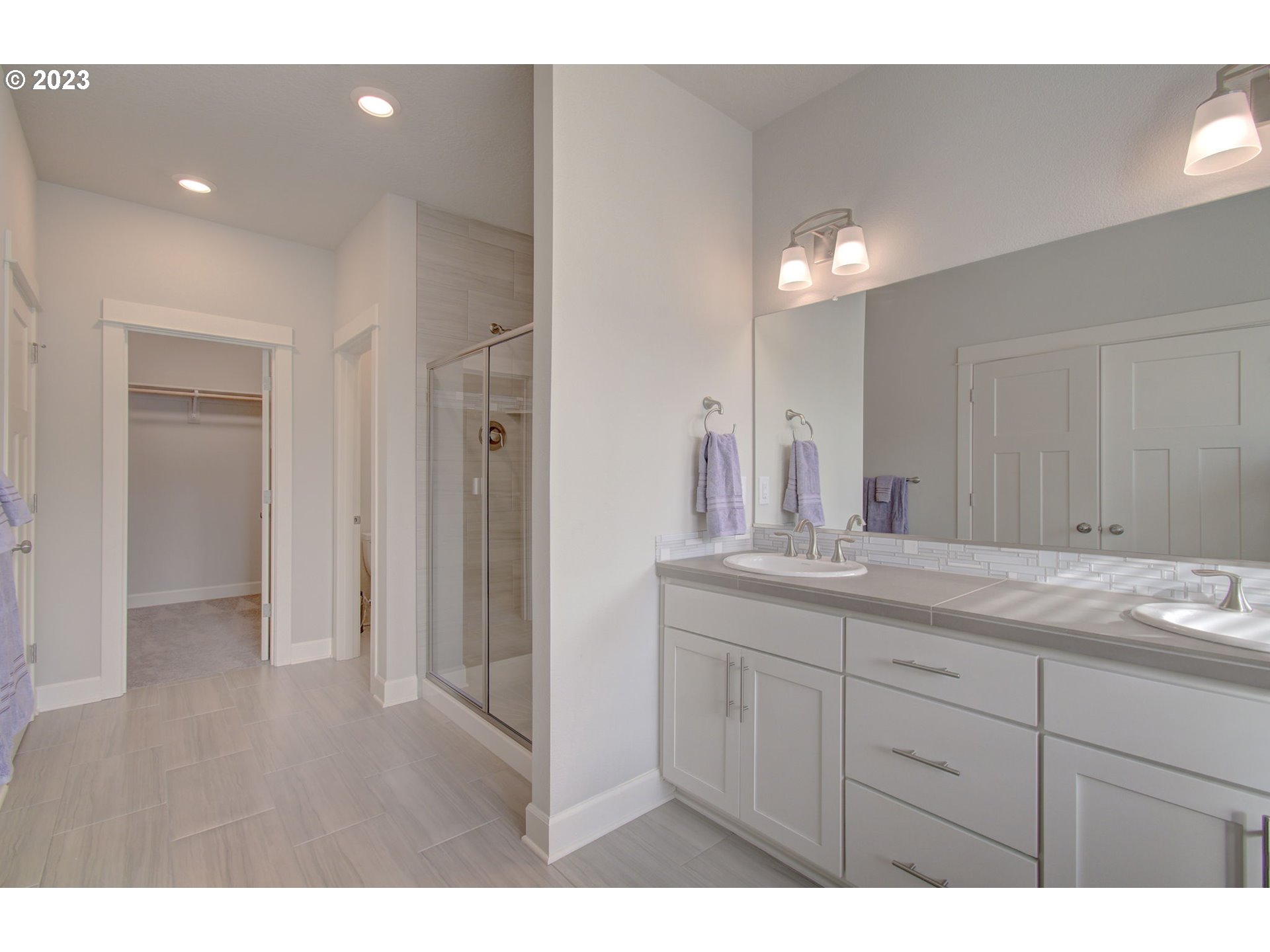 4823 South 16th Drive Ridgefield, WA 98642 - Photo 17 of 37 a bathroom with a double vanity sink and mirror