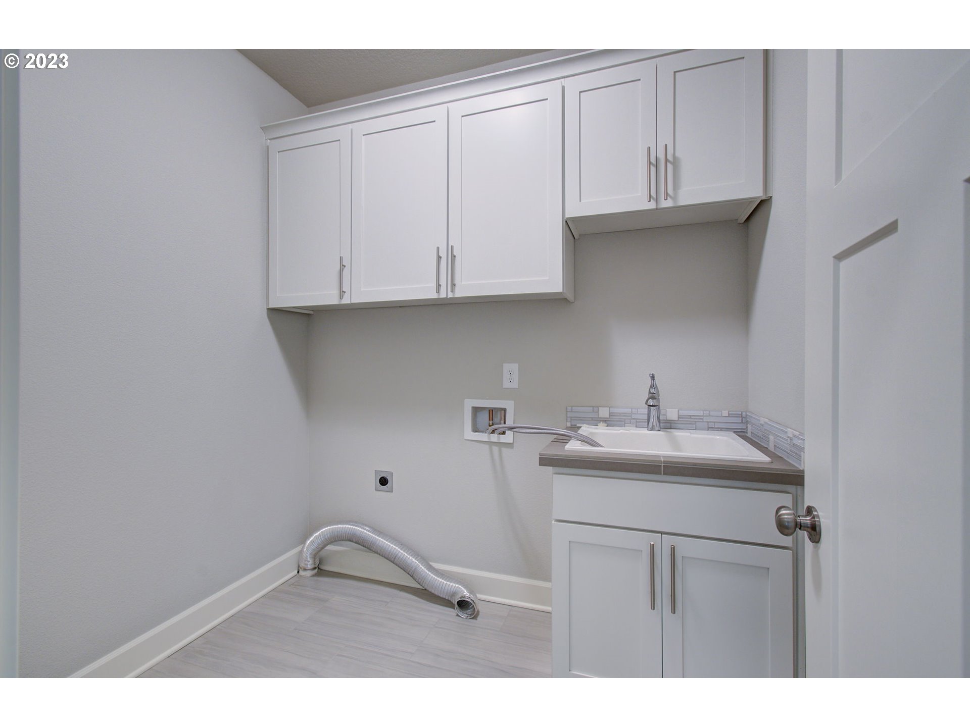 4823 South 16th Drive Ridgefield, WA 98642 - Photo 22 of 37 a kitchen with a sink and cabinets