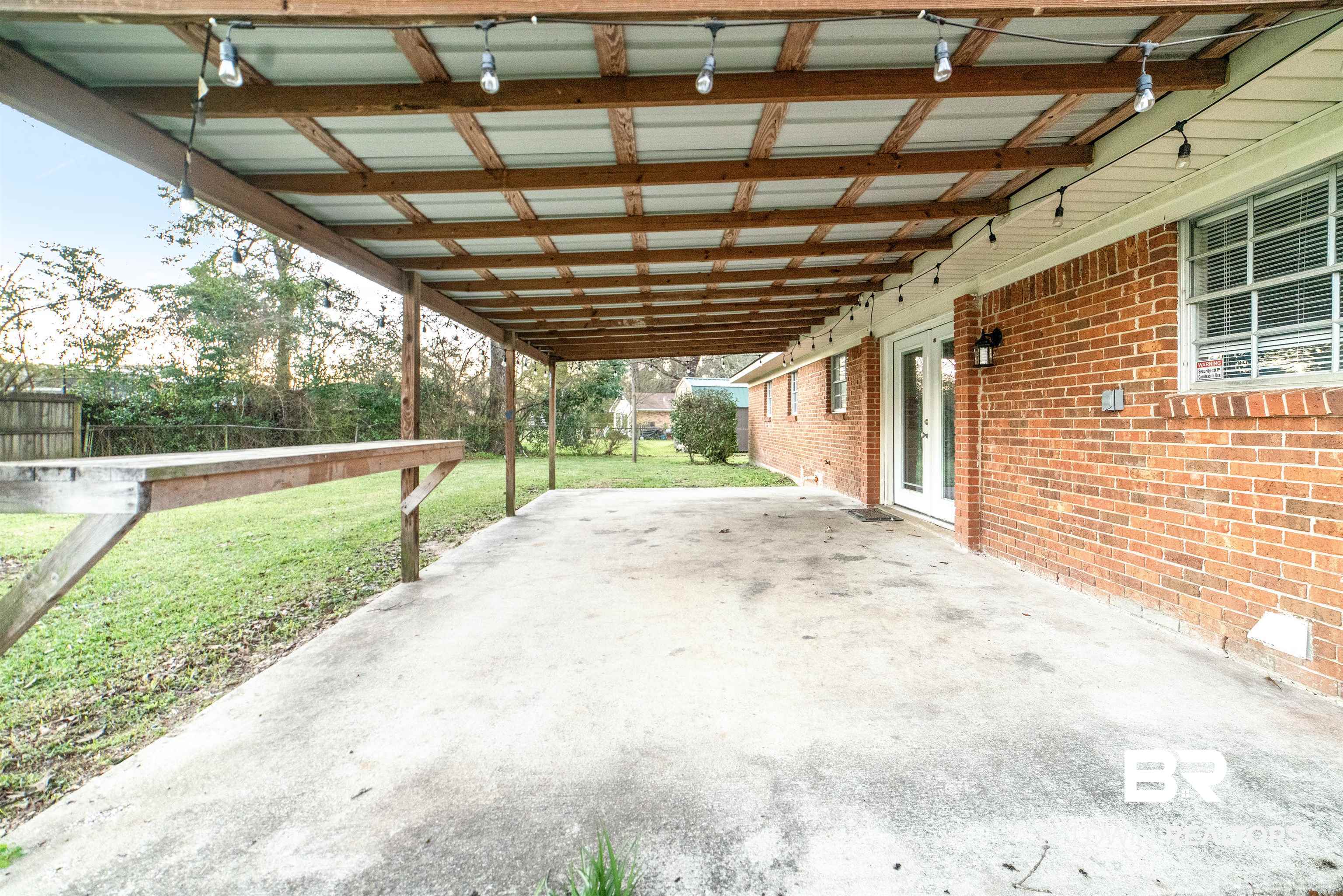 11833 Old Moffat Road Wilmer, AL 36587 - Photo 17 of 23 View of patio featuring a carport and fence
