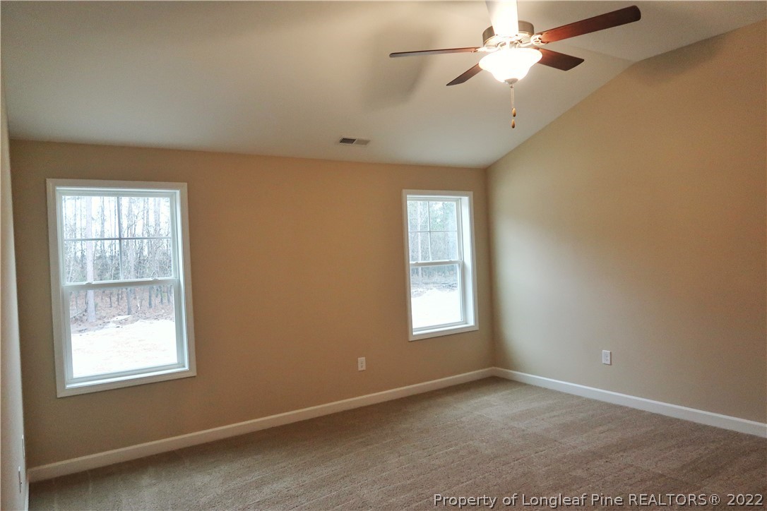 903 Montrose Road Raeford, NC 28376 - Photo 12 of 17 an empty room with windows and fan