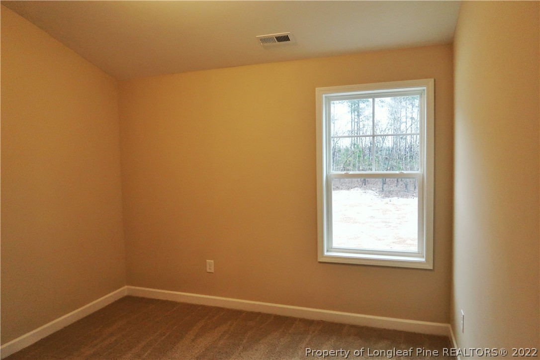 903 Montrose Road Raeford, NC 28376 - Photo 14 of 17 an empty room with a window