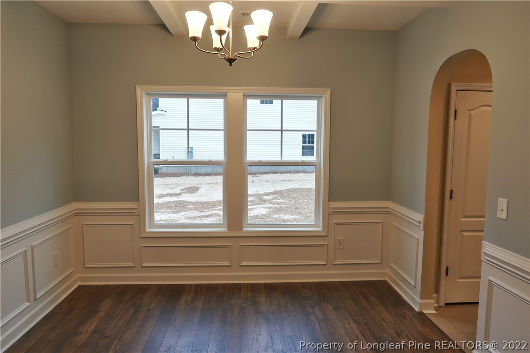 903 Montrose Road Raeford, NC 28376 - Photo 4 of 17 a view of empty room with wooden floor and fan