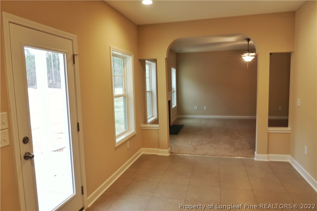 903 Montrose Road Raeford, NC 28376 - Photo 8 of 17 a view of a hallway with wooden floor and a bathroom