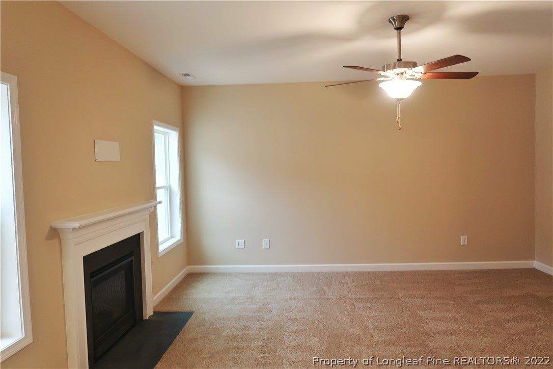 903 Montrose Road Raeford, NC 28376 - Photo 9 of 17 a view of a livingroom with a fireplace and chandelier
