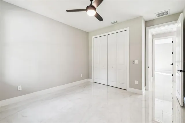 a front view of a house with a garden and plants