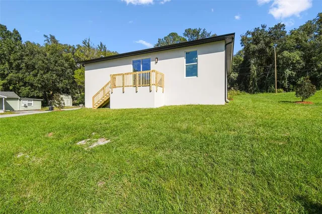 an aerial view of a house with yard
