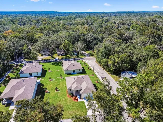 a aerial view of a house with swimming pool and a yard