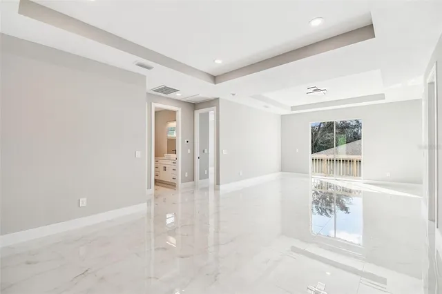 a view of a kitchen with a refrigerator and a sink