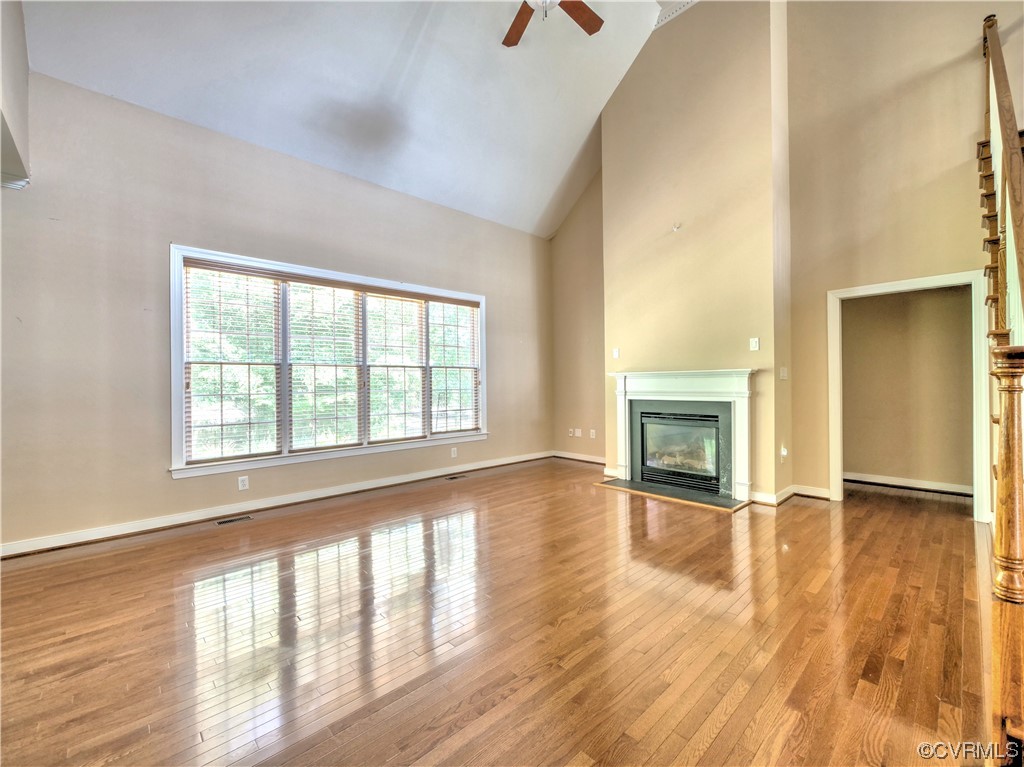 1024 Kingham Drive Midlothian, VA 23114 - Photo 13 of 41 an empty room with wooden floor fireplace and windows