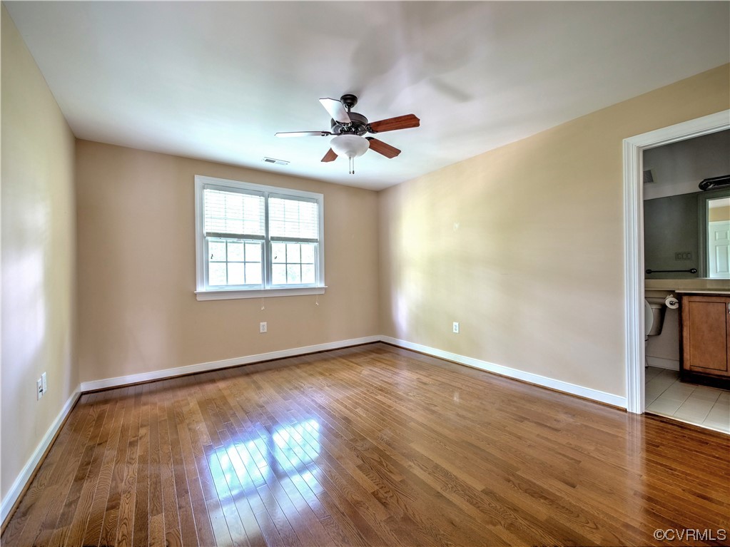1024 Kingham Drive Midlothian, VA 23114 - Photo 29 of 41 an empty room with wooden floor chandelier fan and windows