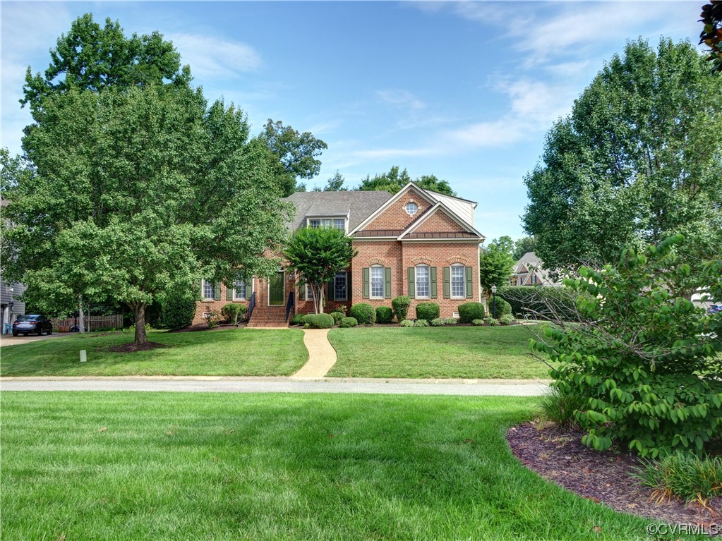1024 Kingham Drive Midlothian, VA 23114 - Photo 5 of 41 a front view of a house with a yard and trees