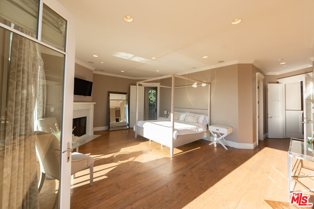 30760 Broad Beach Road Malibu, CA 90265 - Photo 20 of 41 a large bedroom with a bed and glass door