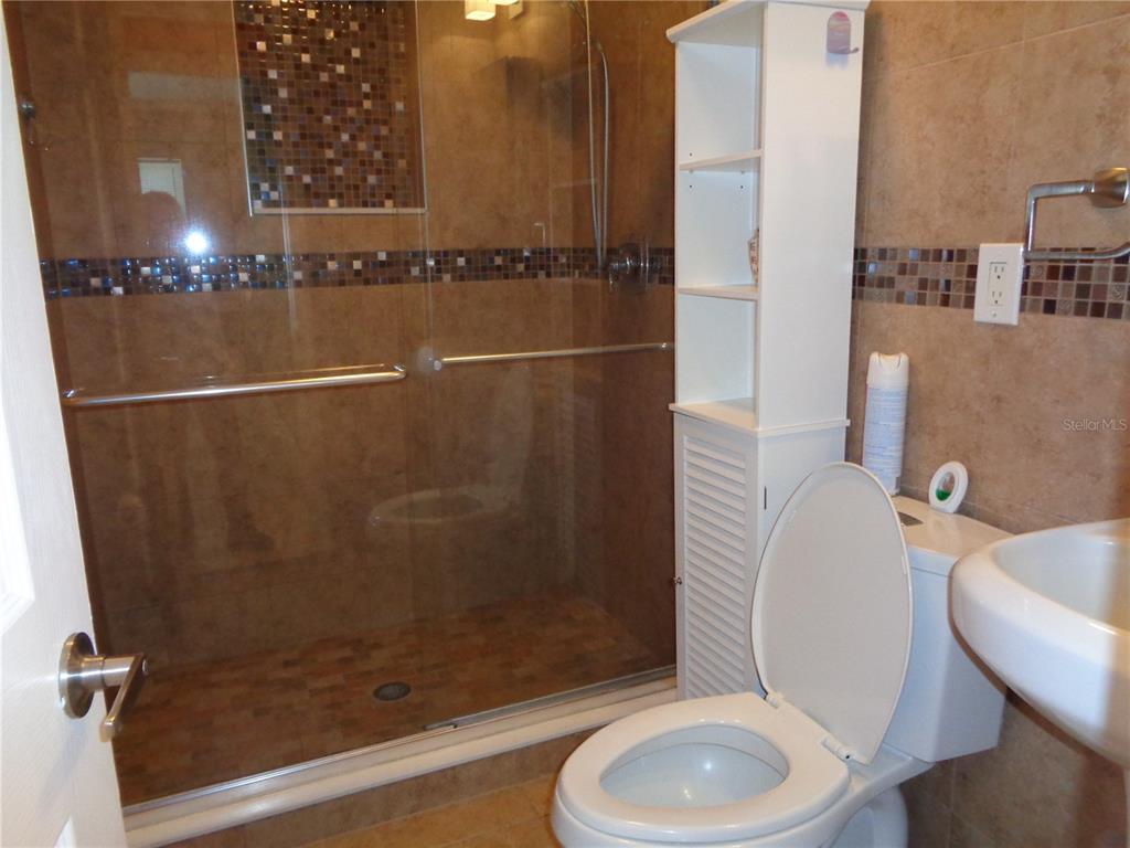 88 Yale Avenue Frostproof, FL 33843 - Photo 24 of 39 a bathroom with a granite countertop sink toilet and shower