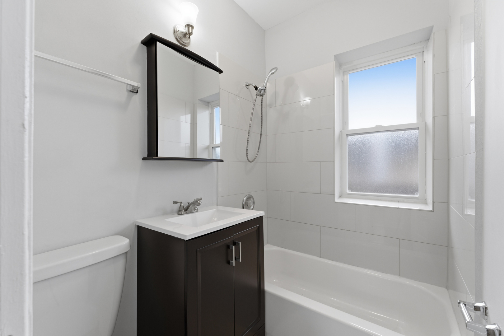 1722 West Juneway Terrace, Unit 3B Chicago, IL 60626 - Photo 10 of 10 a bathroom with a sink and a mirror