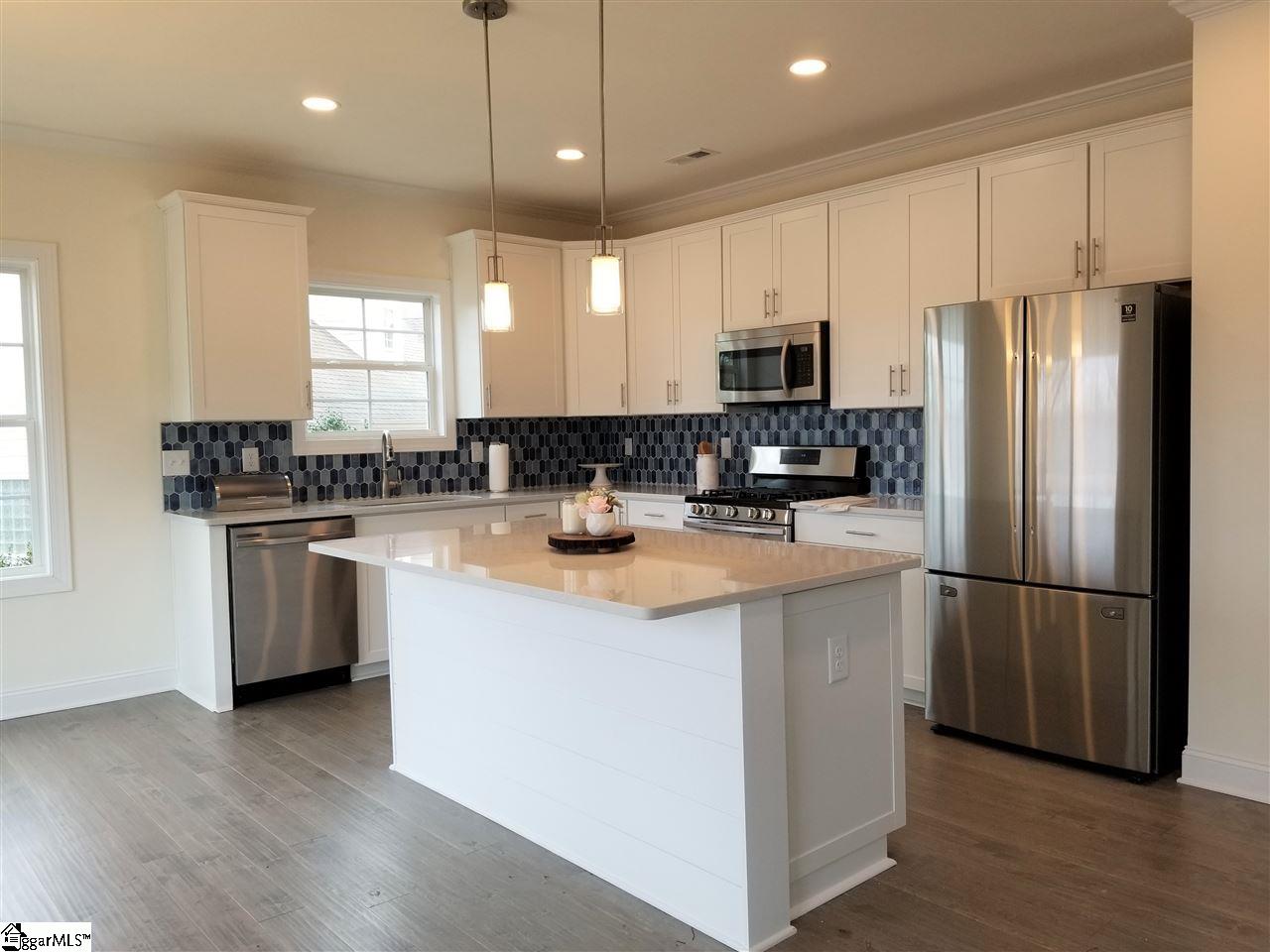 111 Foxfield Way Greer, SC 29651 - Photo 3 of 27 Appliances include brand new SS Fridge, Dishwasher, Gas Range and Microwave, as well as a garbage disposal. The huge island includes a beautiful shiplap front and extra storage underneath. Pantry to right of fridge.
