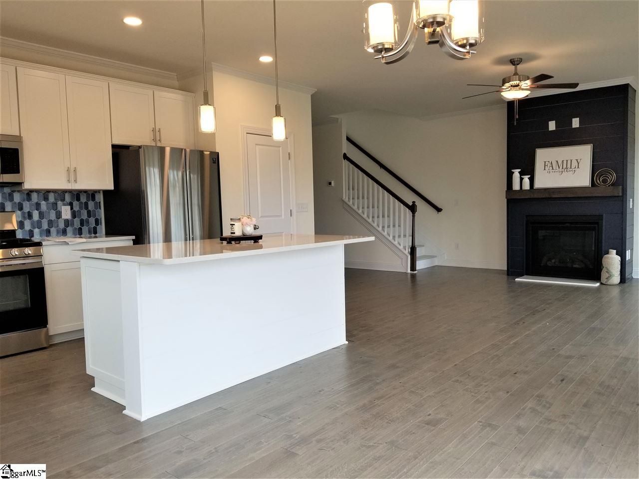 111 Foxfield Way Greer, SC 29651 - Photo 26 of 27 Open floor plan includes the kitchen, dining area with sliding door to 10x10 wood deck and a living area with shiplap electric gaslog fireplace.
