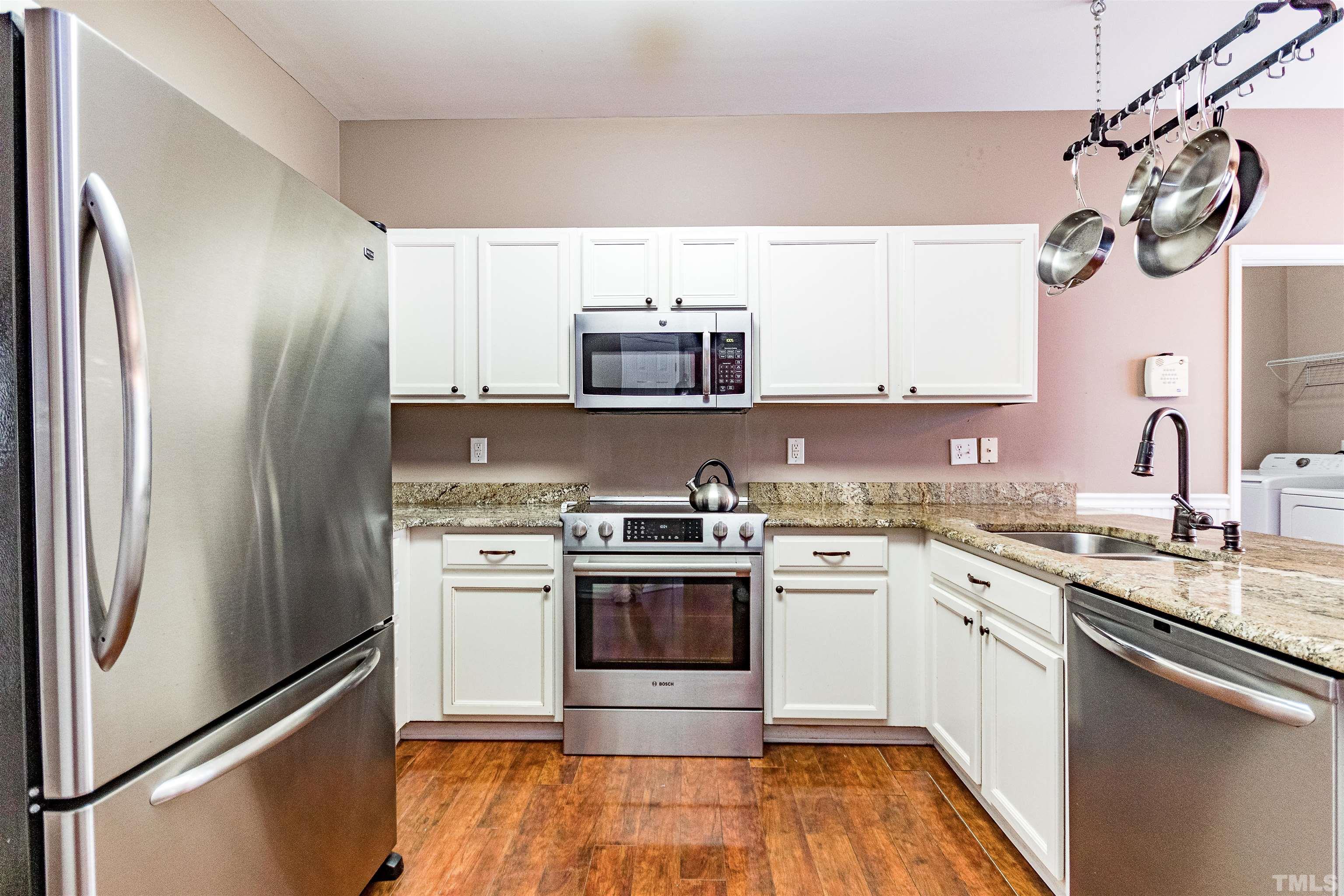 5405 Neuse Forest Road Raleigh, NC 27616 - Photo 16 of 31 a kitchen with stainless steel appliances granite countertop a stove a sink and a refrigerator