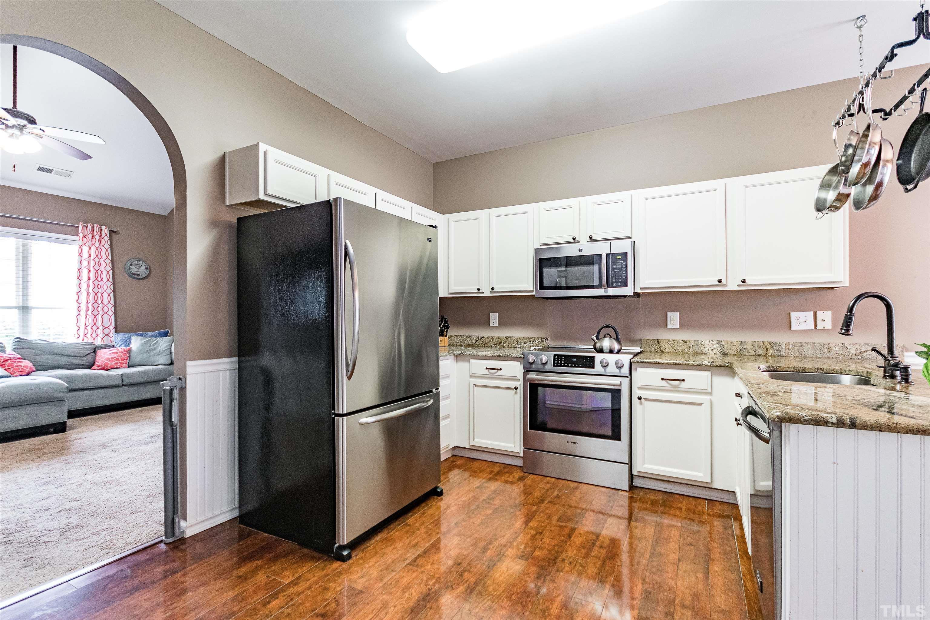 5405 Neuse Forest Road Raleigh, NC 27616 - Photo 17 of 31 a kitchen with stainless steel appliances granite countertop a refrigerator stove and sink