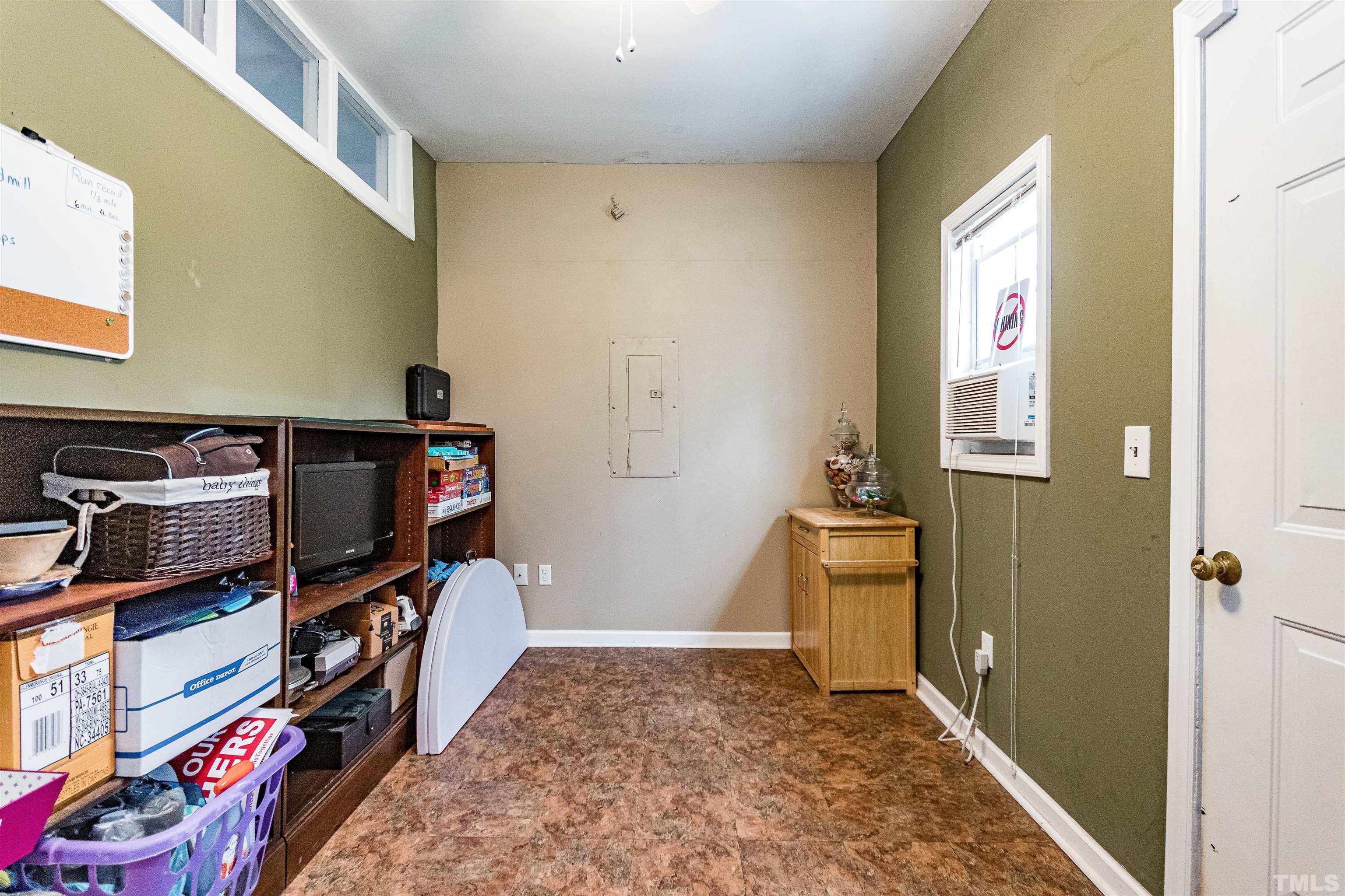 5405 Neuse Forest Road Raleigh, NC 27616 - Photo 19 of 31 a view of a hallway with workspace and wooden floor