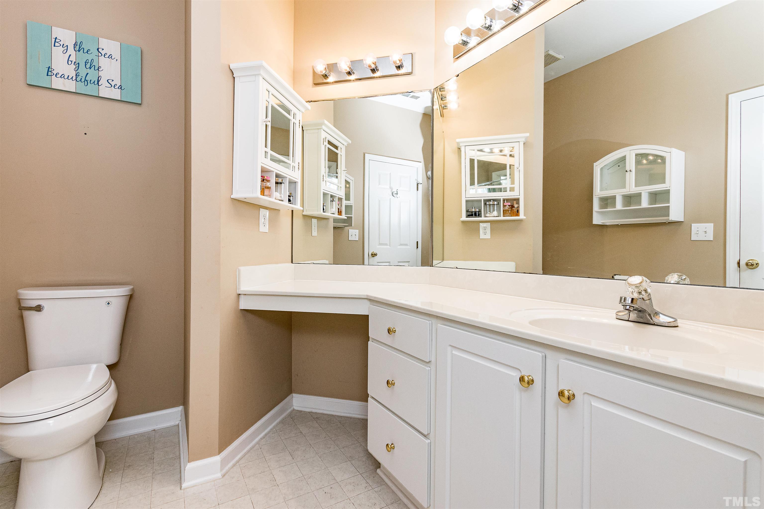 5405 Neuse Forest Road Raleigh, NC 27616 - Photo 22 of 31 a bathroom with a granite countertop sink a toilet and a mirror