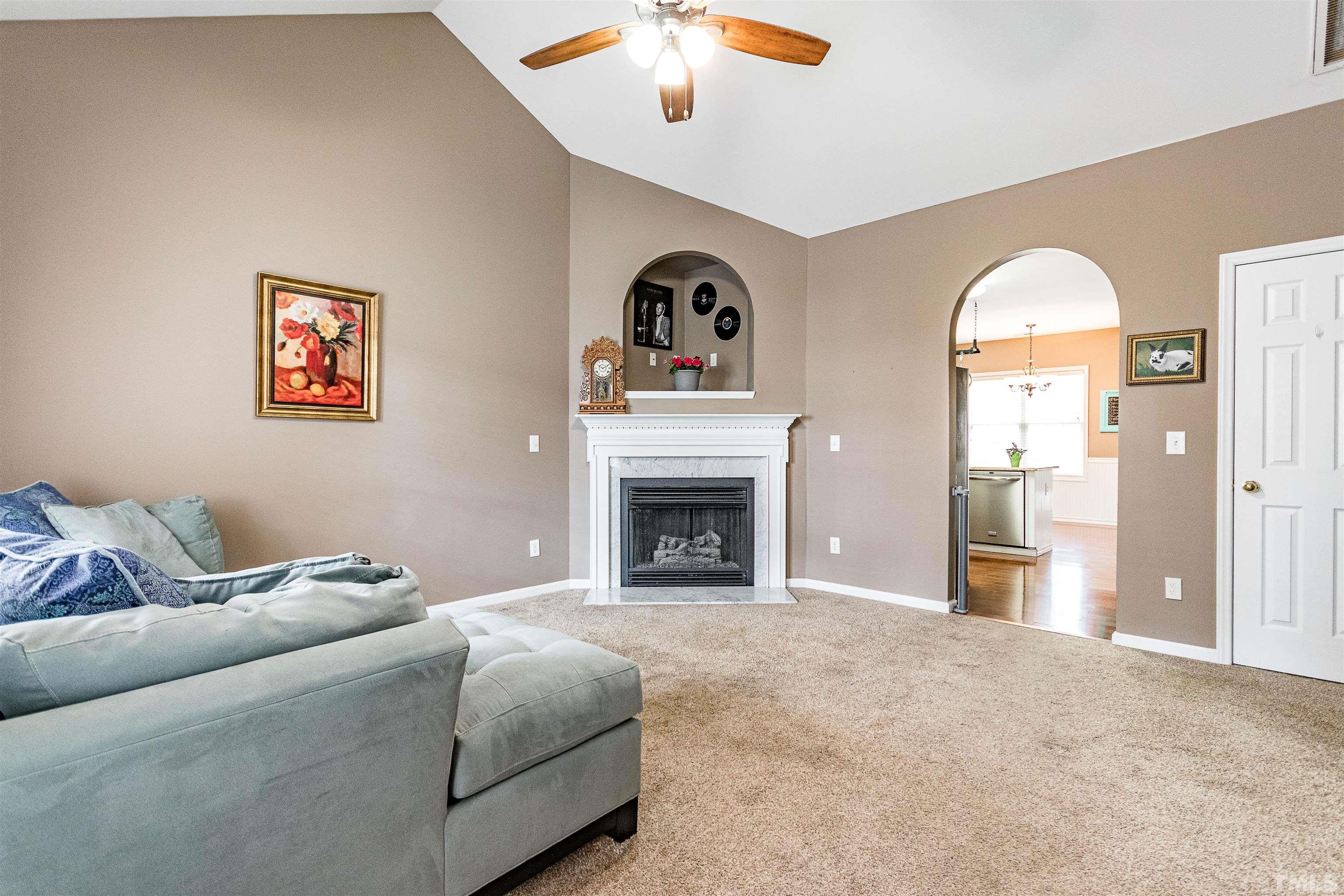 5405 Neuse Forest Road Raleigh, NC 27616 - Photo 27 of 31 a living room with furniture and a fireplace