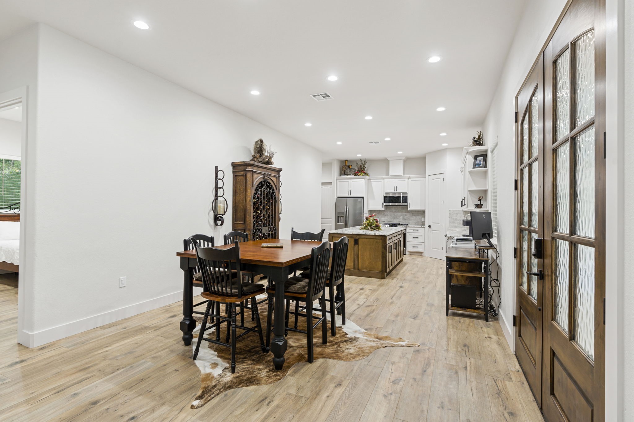 6970 Longmire Road Conroe, TX 77304 - Photo 16 of 48 a view of a dining room with furniture and wooden floor