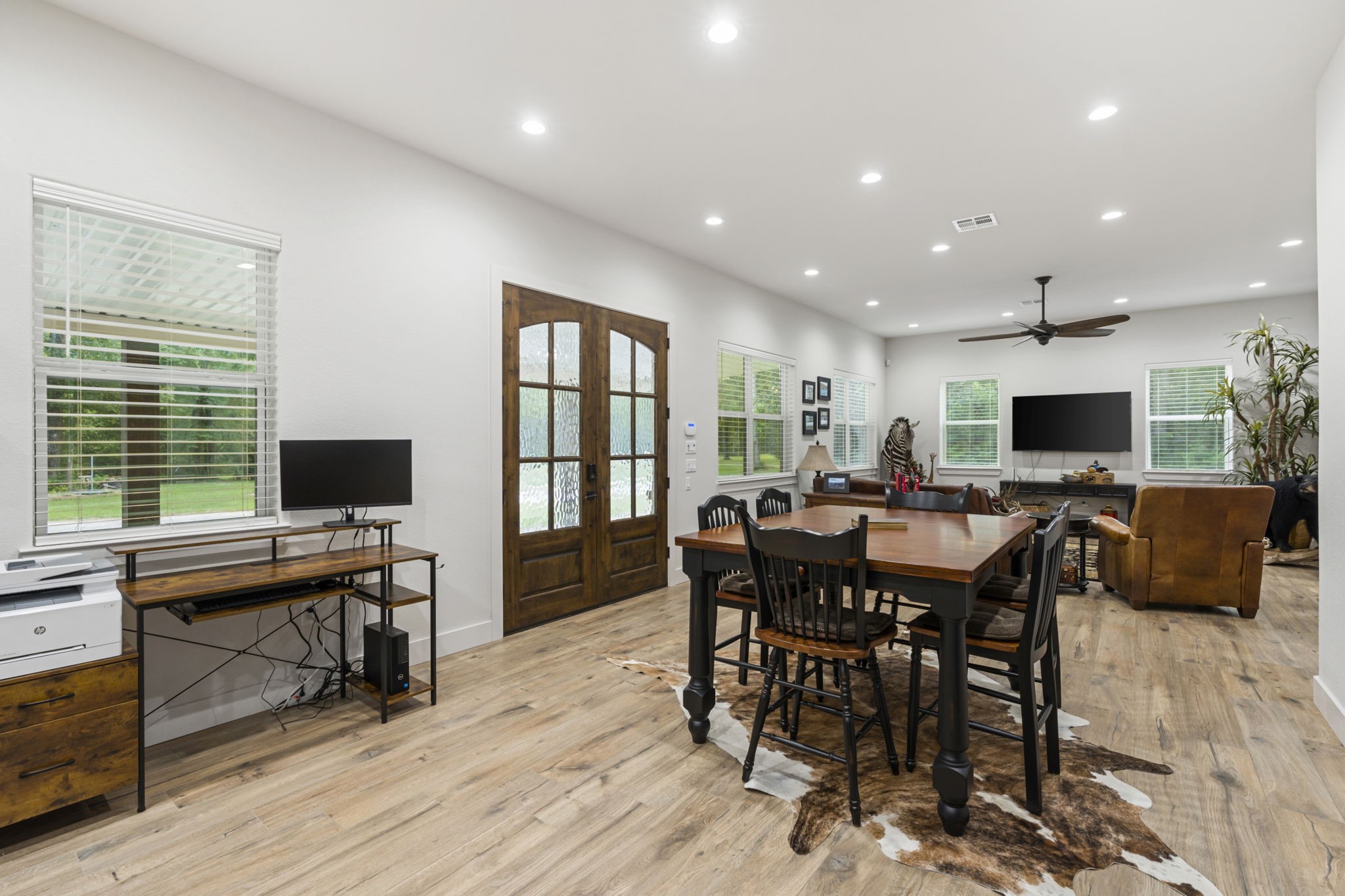 6970 Longmire Road Conroe, TX 77304 - Photo 17 of 48 a view of a dining room with furniture window and wooden floor