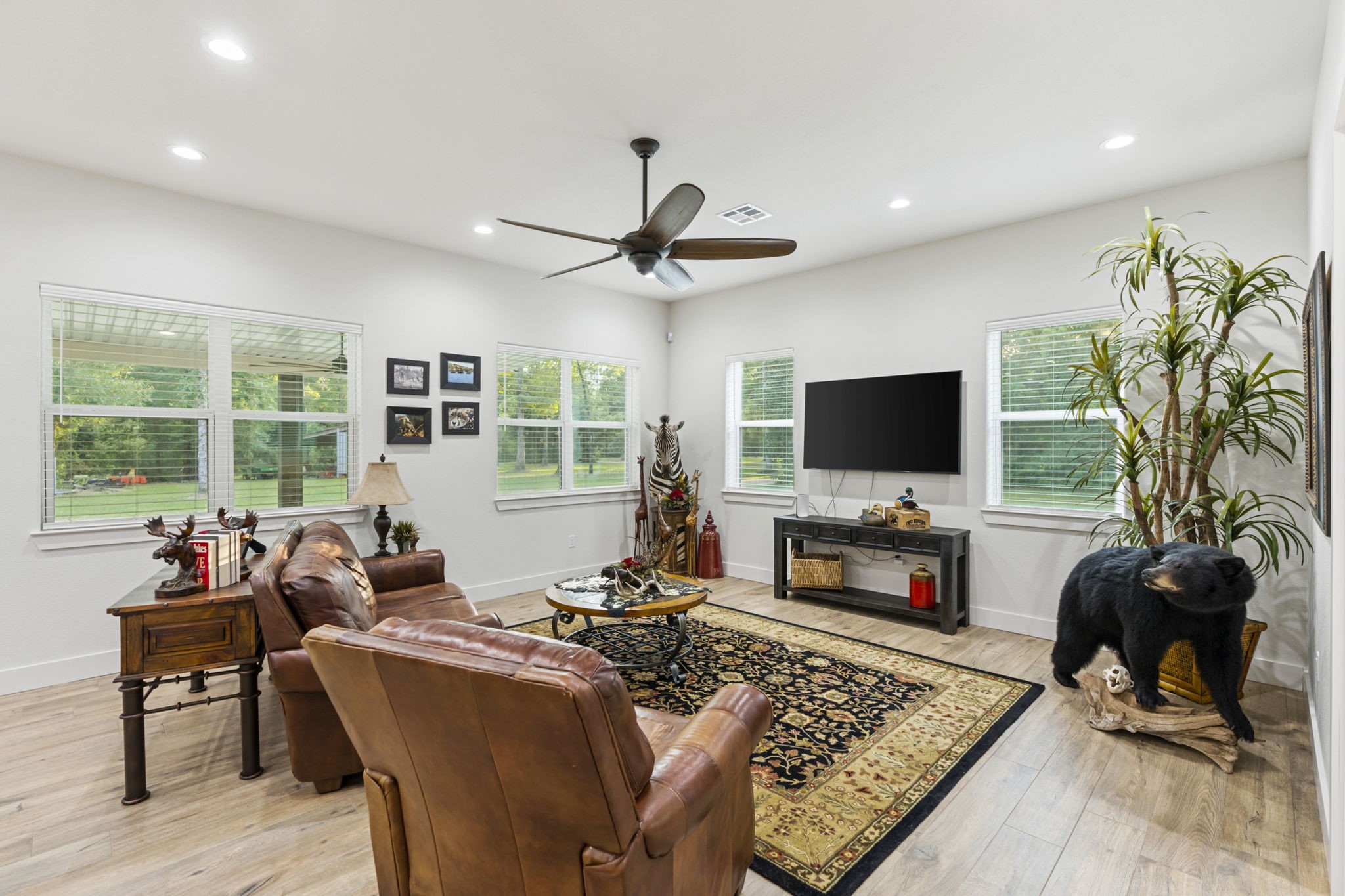 6970 Longmire Road Conroe, TX 77304 - Photo 18 of 48 a living room with furniture a flat screen tv and a fireplace