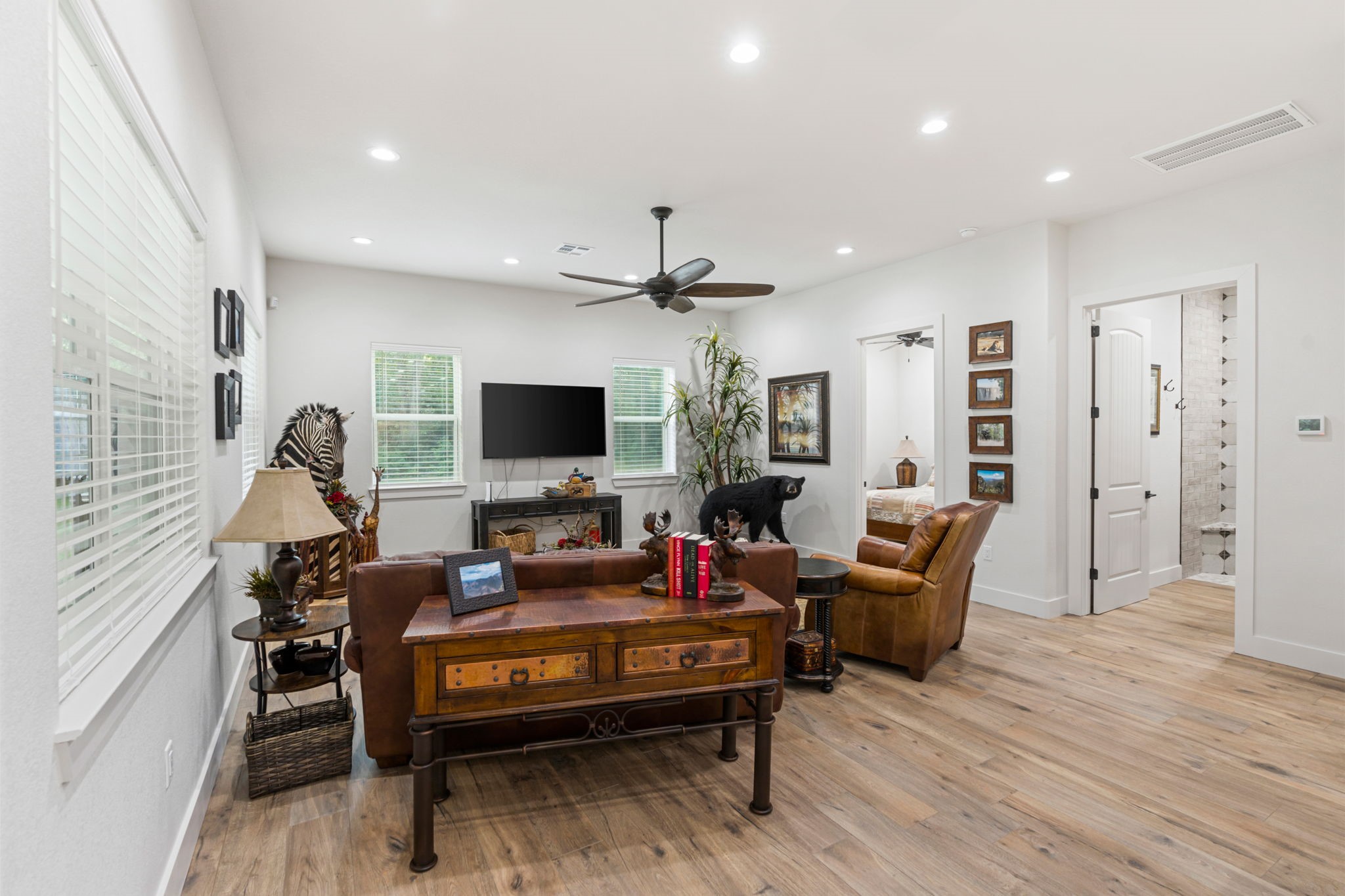 6970 Longmire Road Conroe, TX 77304 - Photo 19 of 48 a living room with furniture and a flat screen tv