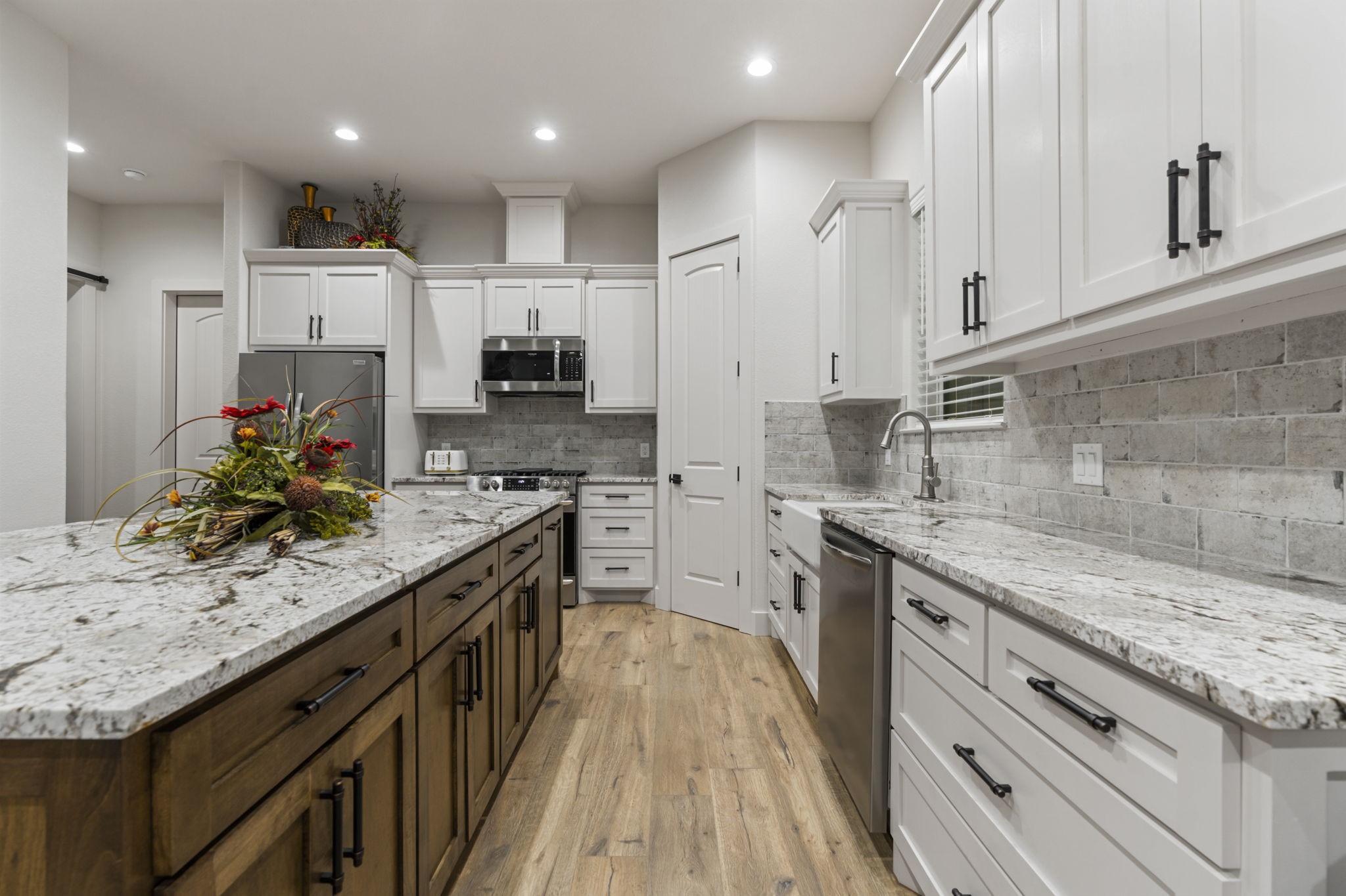 6970 Longmire Road Conroe, TX 77304 - Photo 23 of 48 a kitchen with stainless steel appliances granite countertop a sink stove and refrigerator
