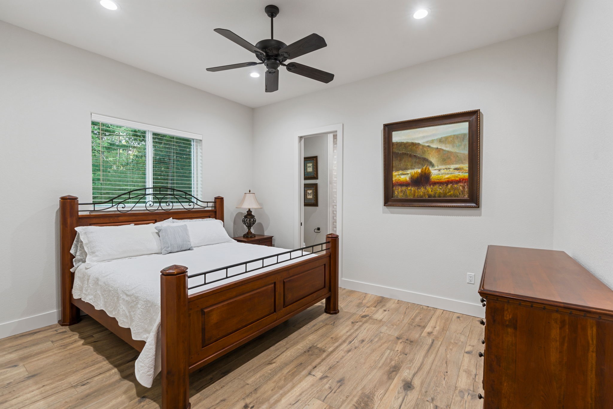 6970 Longmire Road Conroe, TX 77304 - Photo 25 of 48 a bedroom with a bed and a bookshelf