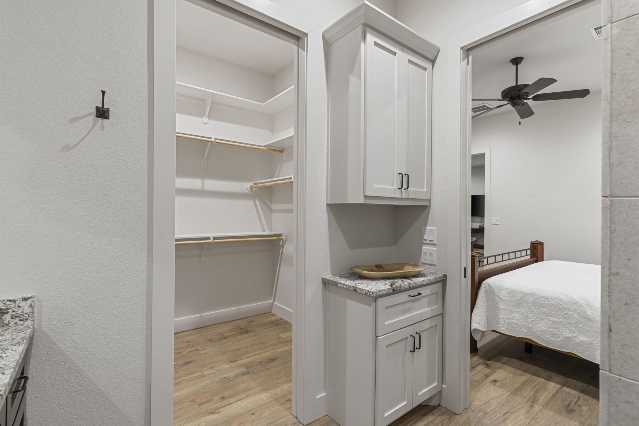 6970 Longmire Road Conroe, TX 77304 - Photo 27 of 48 a bedroom with a bed and a cabinets