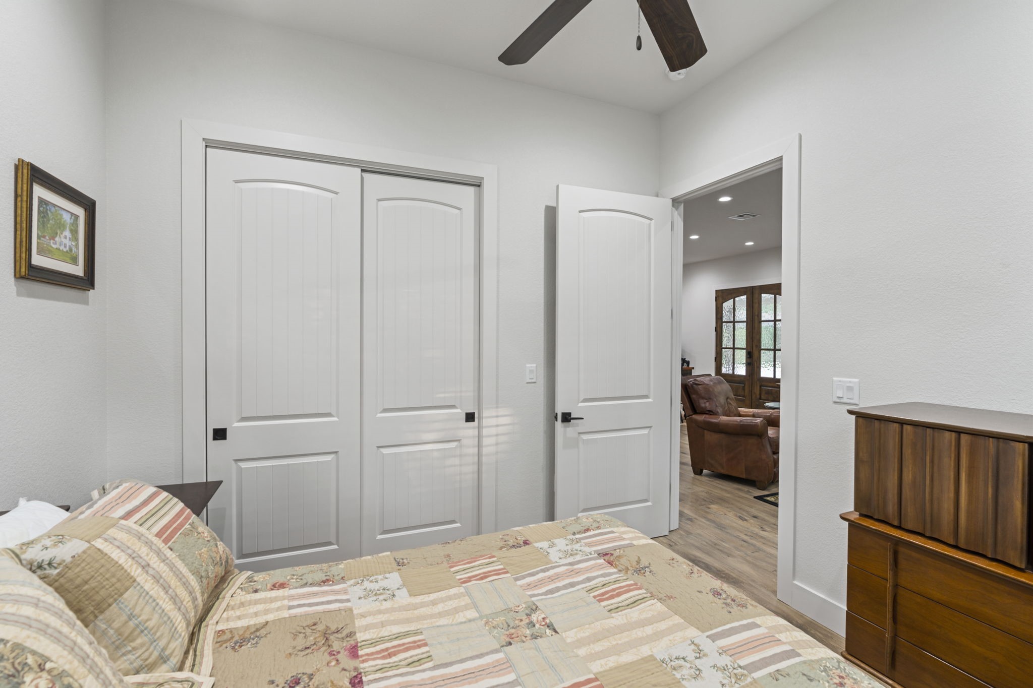 6970 Longmire Road Conroe, TX 77304 - Photo 31 of 48 a bedroom with a bed and a chandelier