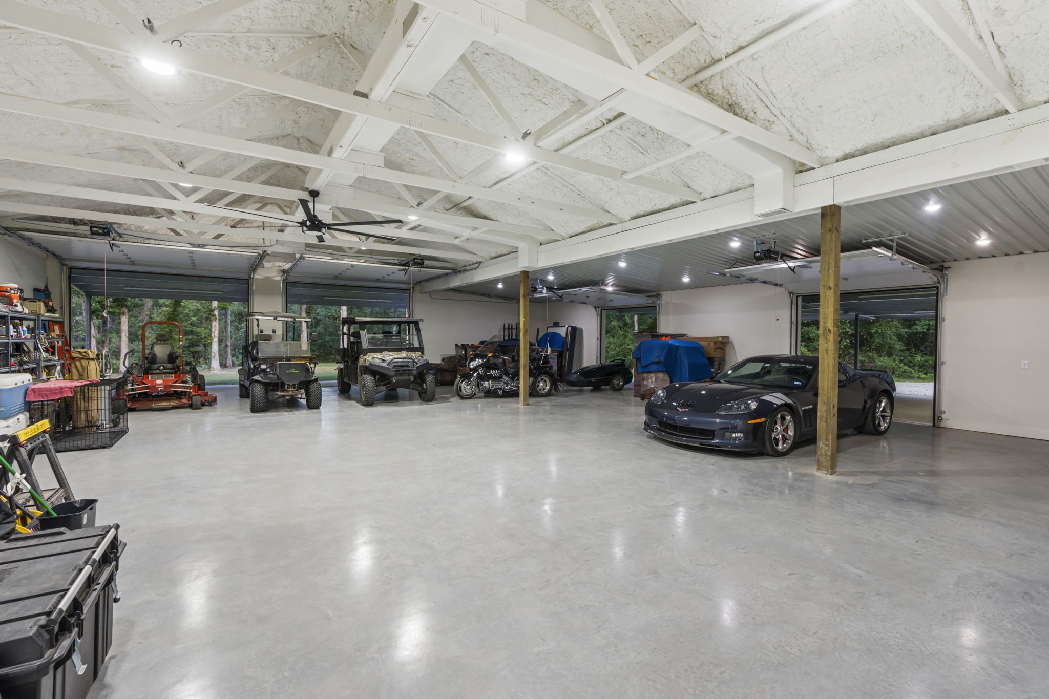 6970 Longmire Road Conroe, TX 77304 - Photo 38 of 48 a view of parking garage with cars and other equipment