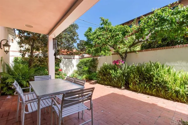 a view of a patio with table and chairs and potted plants