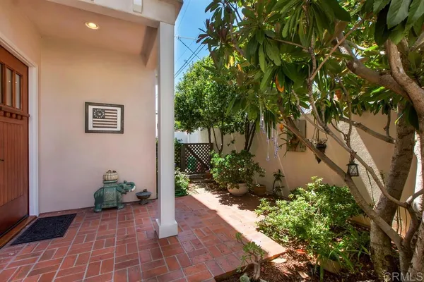 a view of a hallway with flower plants