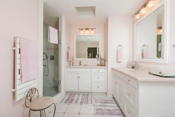 a spacious bathroom with a double vanity sink mirror and
